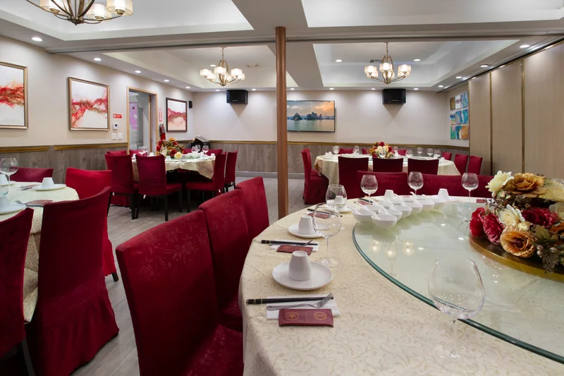 Round banquet tables set for a party in the private dining room