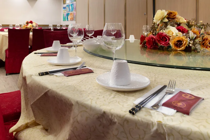 A place setting with glassware and chopsticks on a banquet table